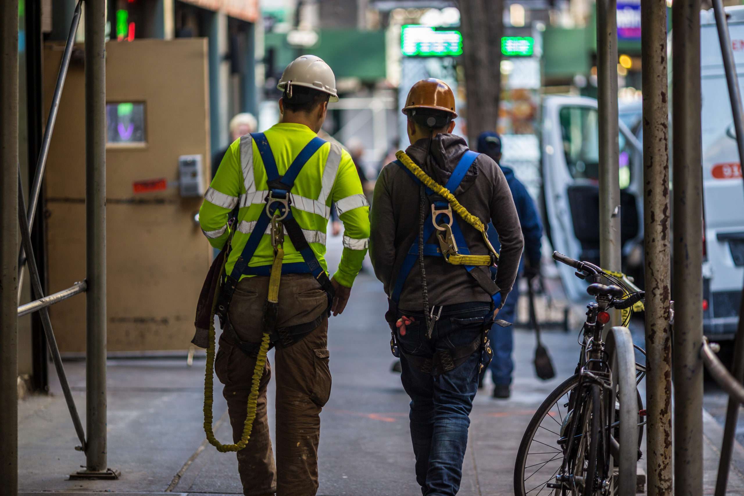 Two Construction Workers Walk Down A NYC Street