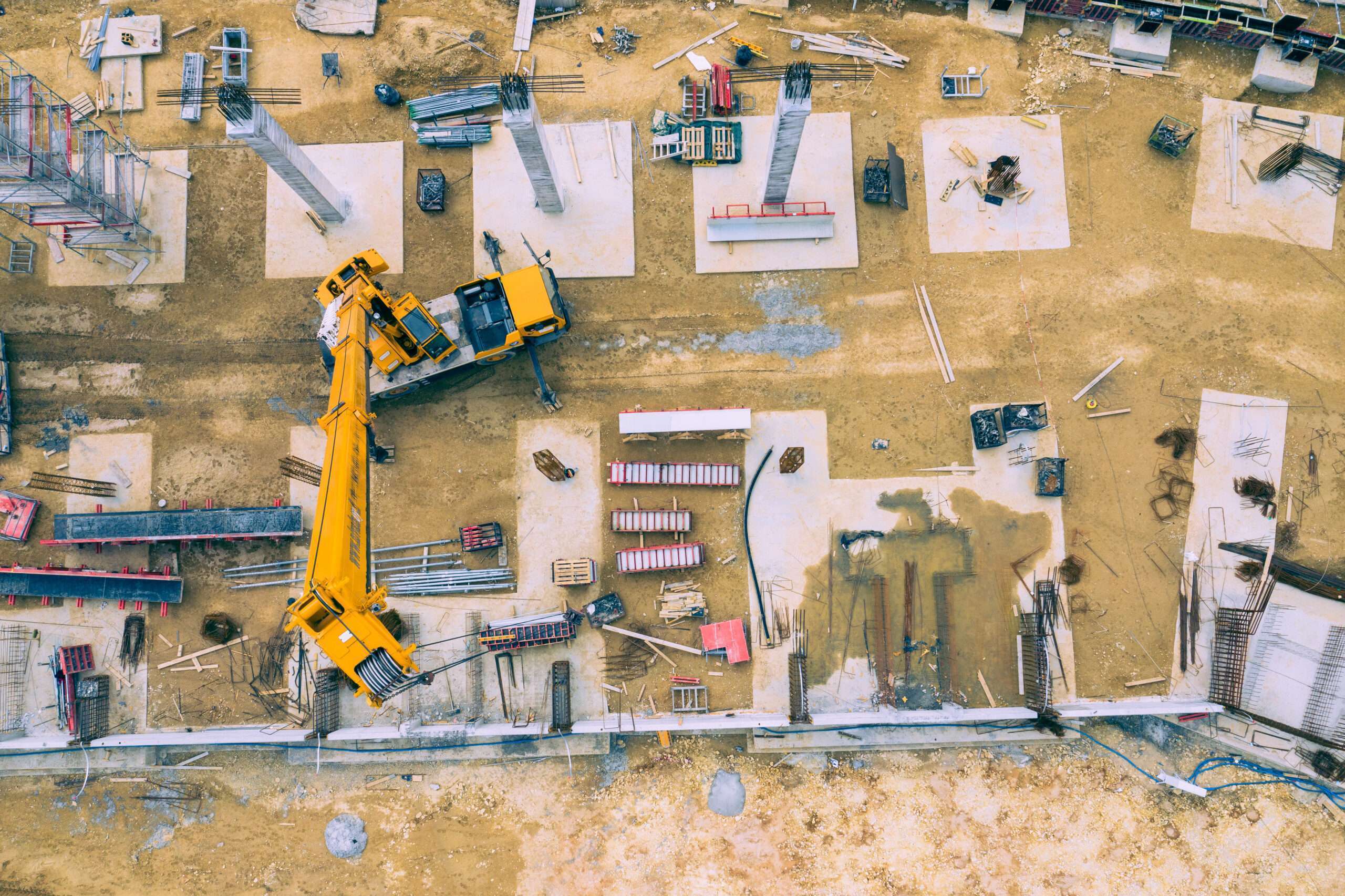 AI Powered Drones Construction site from above. Aerial view of workplaces in construction equipment, workers with heavy machinery. Industrial top view made by drone.